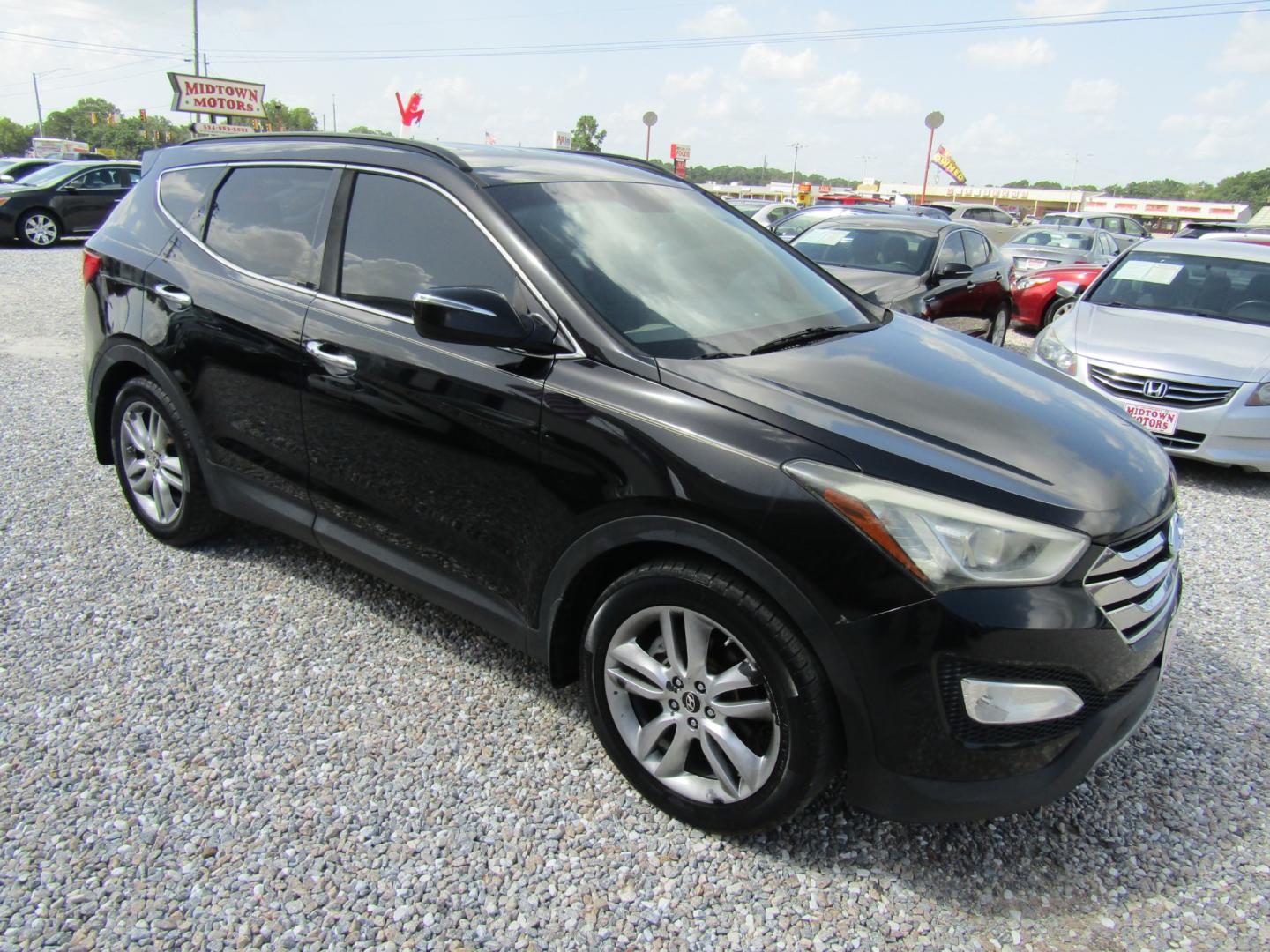 2013 Black /Tan Hyundai Santa Fe Sport 2.0 FWD (5XYZU3LAXDG) with an 2.0L L4 DOHC 16V engine, Automatic transmission, located at 15016 S Hwy 231, Midland City, AL, 36350, (334) 983-3001, 31.306210, -85.495277 - Photo#0