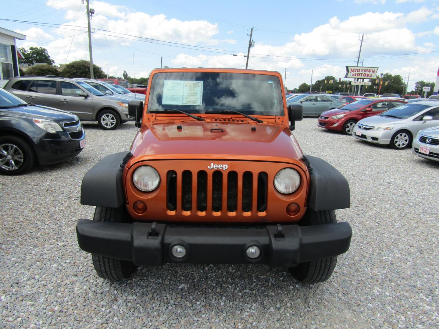 2011 Orange /Black Jeep Wrangler Unlimited Sport 4WD (1J4BA3H16BL) with an 3.8L V6 OHV 12V engine, Automatic transmission, located at 15016 S Hwy 231, Midland City, AL, 36350, (334) 983-3001, 31.306210, -85.495277 - Photo#1