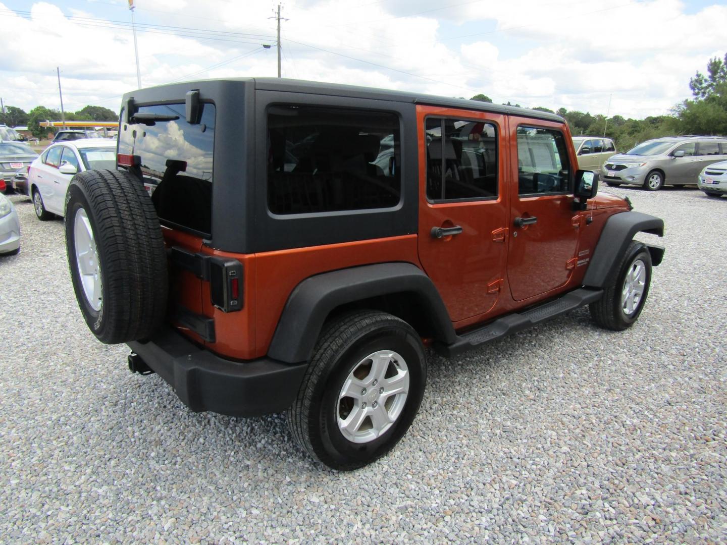 2011 Orange /Black Jeep Wrangler Unlimited Sport 4WD (1J4BA3H16BL) with an 3.8L V6 OHV 12V engine, Automatic transmission, located at 15016 S Hwy 231, Midland City, AL, 36350, (334) 983-3001, 31.306210, -85.495277 - Photo#7