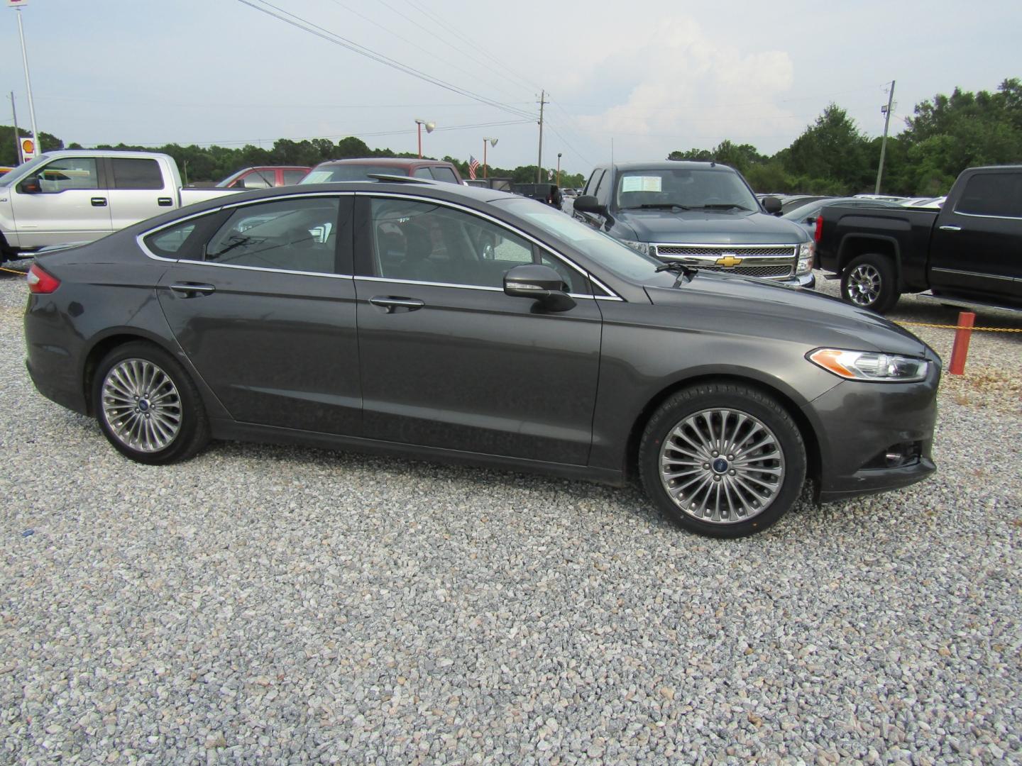 2016 Gray Ford Fusion Titanium (3FA6P0K97GR) with an 2.0L L4 DOHC 16V engine, Automatic transmission, located at 15016 S Hwy 231, Midland City, AL, 36350, (334) 983-3001, 31.306210, -85.495277 - Photo#0