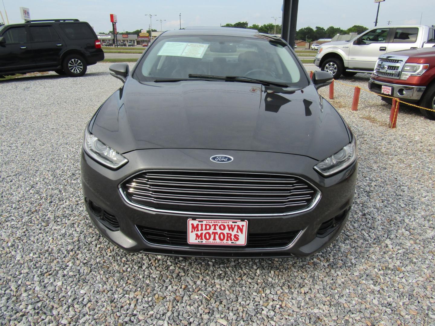 2016 Gray Ford Fusion Titanium (3FA6P0K97GR) with an 2.0L L4 DOHC 16V engine, Automatic transmission, located at 15016 S Hwy 231, Midland City, AL, 36350, (334) 983-3001, 31.306210, -85.495277 - Photo#1