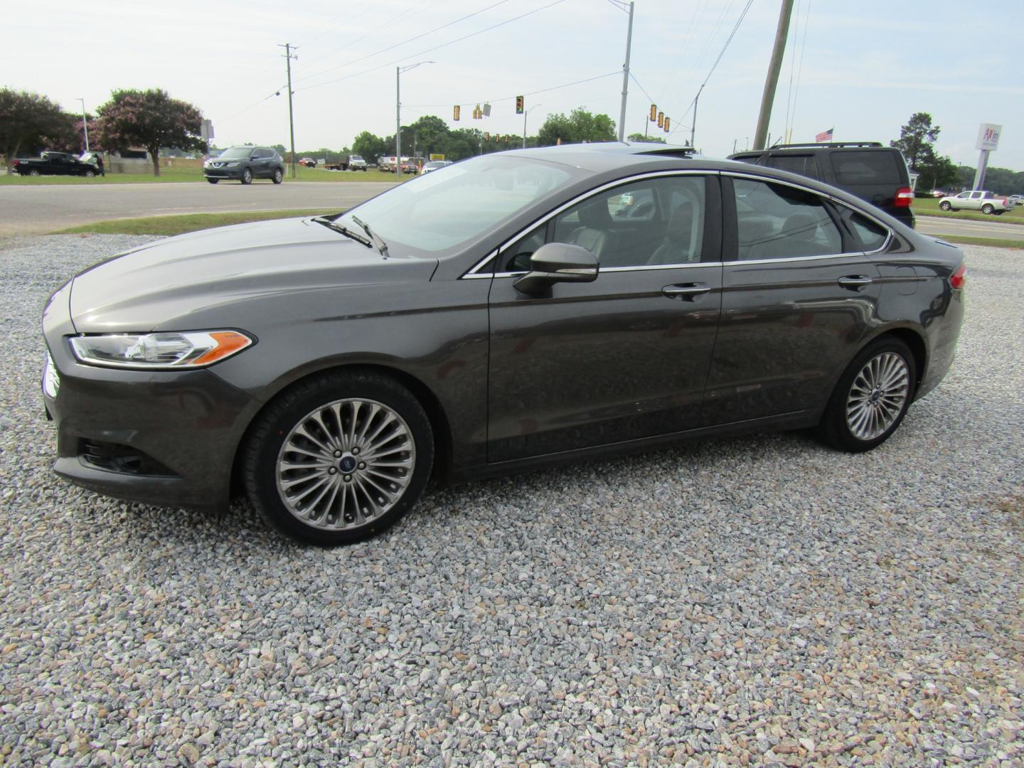 2016 Gray Ford Fusion Titanium (3FA6P0K97GR) with an 2.0L L4 DOHC 16V engine, Automatic transmission, located at 15016 S Hwy 231, Midland City, AL, 36350, (334) 983-3001, 31.306210, -85.495277 - Photo#2