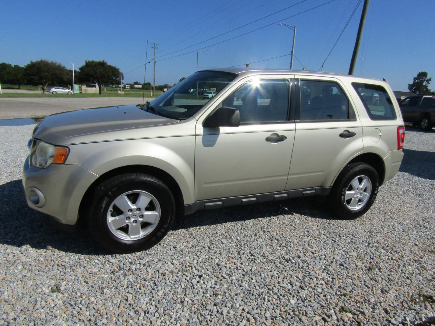 2010 Gold Ford Escape XLS FWD (1FMCU0C76AK) with an 2.5L L4 DOHC 16V engine, Automatic transmission, located at 15016 S Hwy 231, Midland City, AL, 36350, (334) 983-3001, 31.306210, -85.495277 - Photo#2