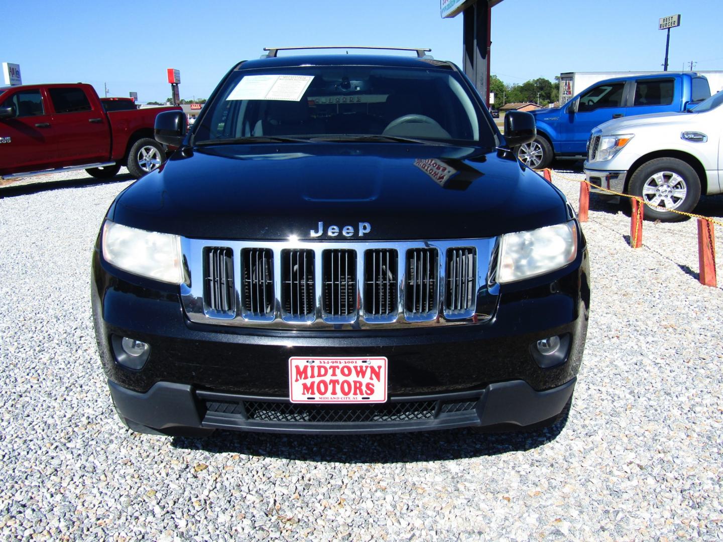 2012 Black /Tan Jeep Grand Cherokee Laredo 2WD (1C4RJEAG2CC) with an 3.6L V6 DOHC 24V engine, Automatic transmission, located at 15016 S Hwy 231, Midland City, AL, 36350, (334) 983-3001, 31.306210, -85.495277 - Photo#1