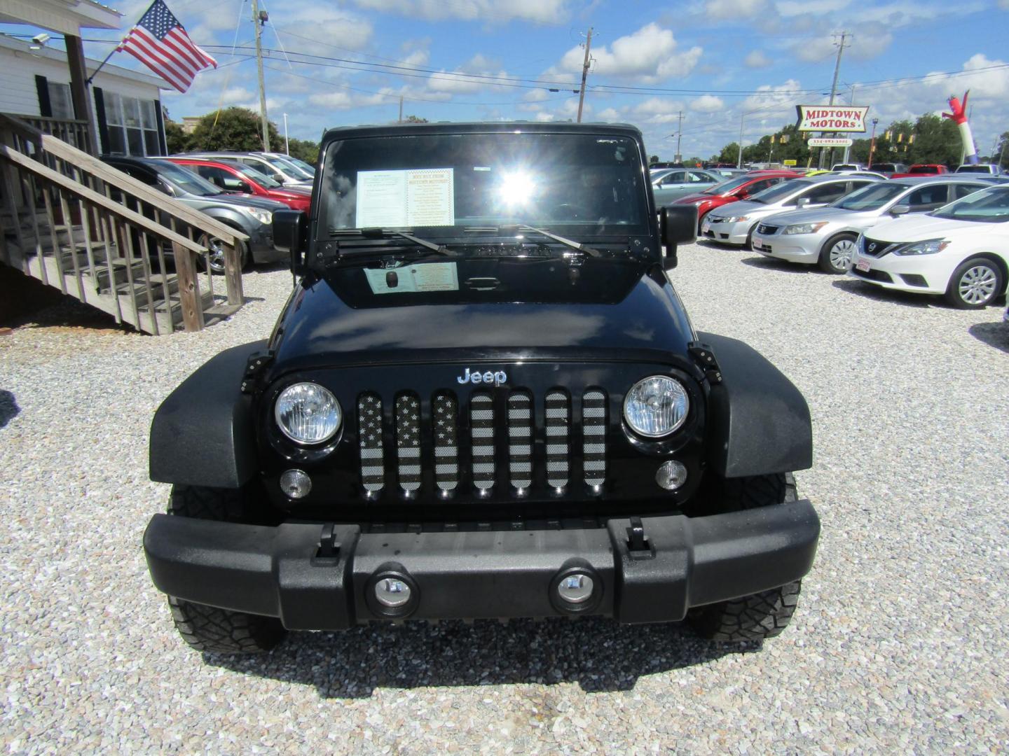 2016 Black Jeep Wrangler Unlimited Sport 4WD (1C4BJWDG9GL) with an 3.6L V6 DOHC 24V FFV engine, Automatic transmission, located at 15016 S Hwy 231, Midland City, AL, 36350, (334) 983-3001, 31.306210, -85.495277 - Photo#1