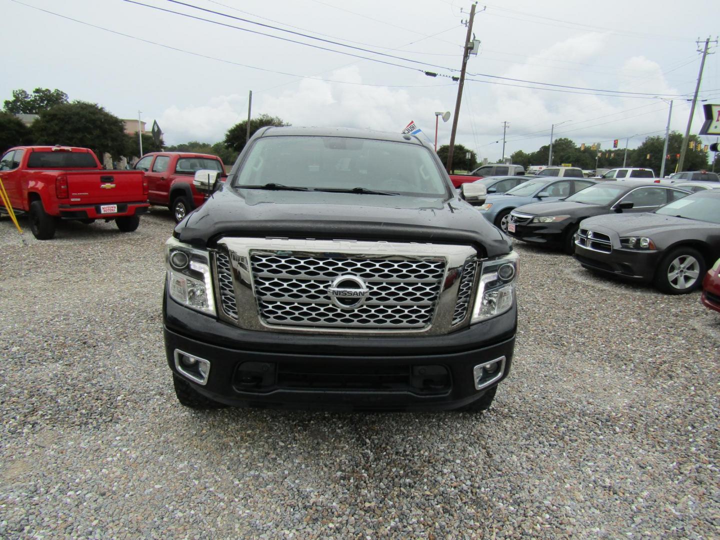 2017 Black Nissan Titan Platinum Reserve Crew Cab 4WD (1N6AA1E5XHN) with an 5.6L V8 DOHC 32V engine, Automatic transmission, located at 15016 S Hwy 231, Midland City, AL, 36350, (334) 983-3001, 31.306210, -85.495277 - Photo#1