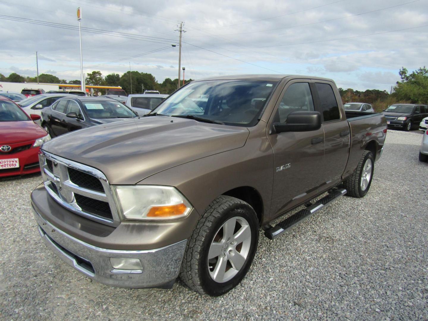 2009 Gold Dodge Ram 1500 SLT Quad Cab 2WD (1D3HB18P29S) with an 4.7L V8 SOHC 16V FFV engine, Automatic transmission, located at 15016 S Hwy 231, Midland City, AL, 36350, (334) 983-3001, 31.306210, -85.495277 - Photo#1