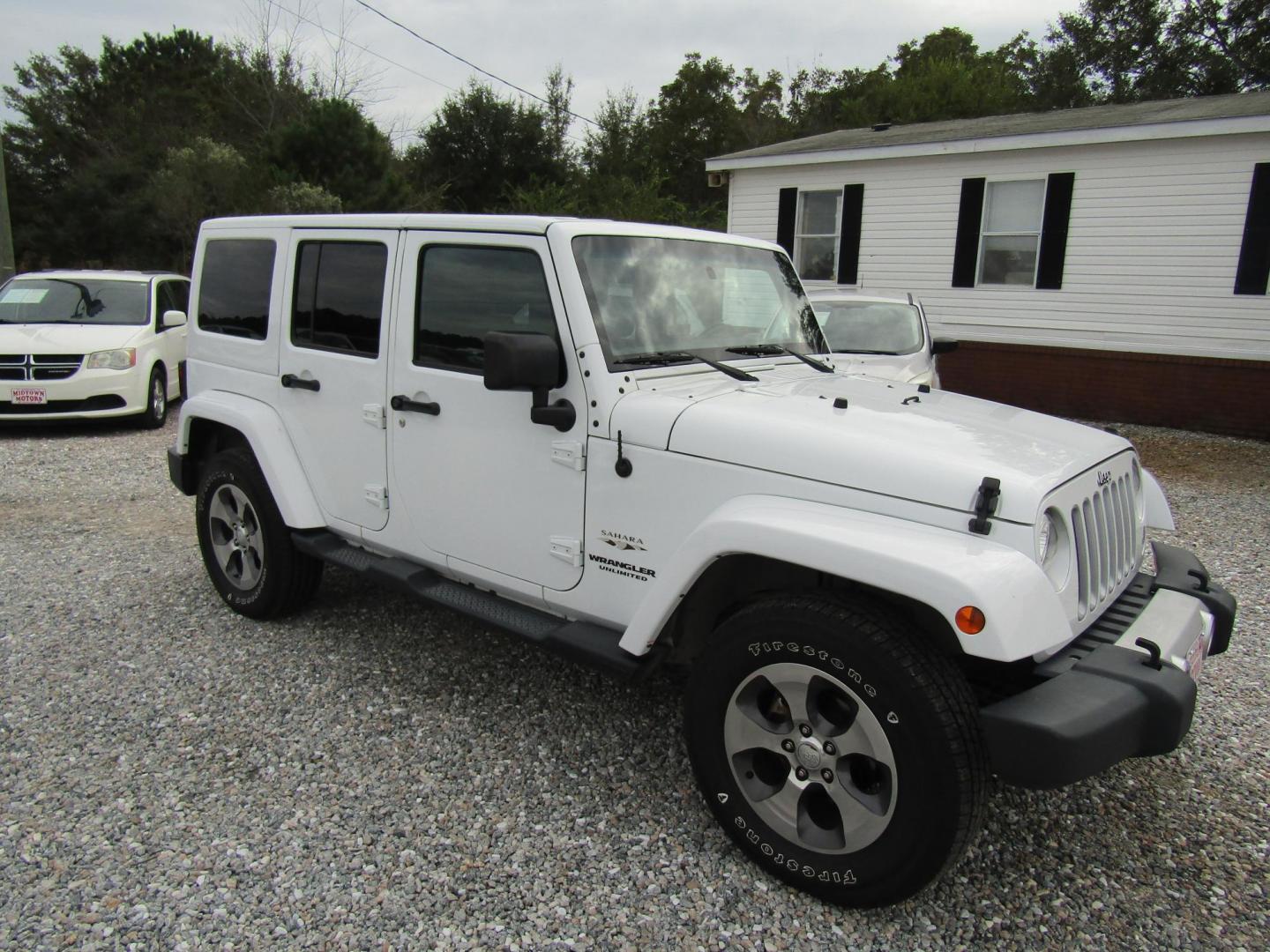 2017 White Jeep Wrangler Unlimited Sahara 4WD (1C4BJWEG0HL) with an 3.6L V6 DOHC 24V FFV engine, Automatic transmission, located at 15016 S Hwy 231, Midland City, AL, 36350, (334) 983-3001, 31.306210, -85.495277 - Photo#0